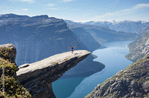 female gymnast doing a handstand on trolltunga rock in norway