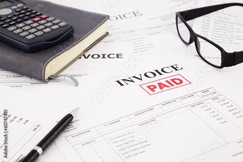 invoice and bills with paid stamp