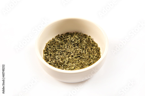 Dried oregano in a white ceramic bowl