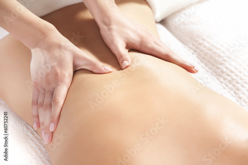woman giving back massage to a girl photo