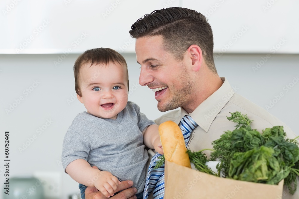 Fototapeta premium Happy baby being carried by businessman