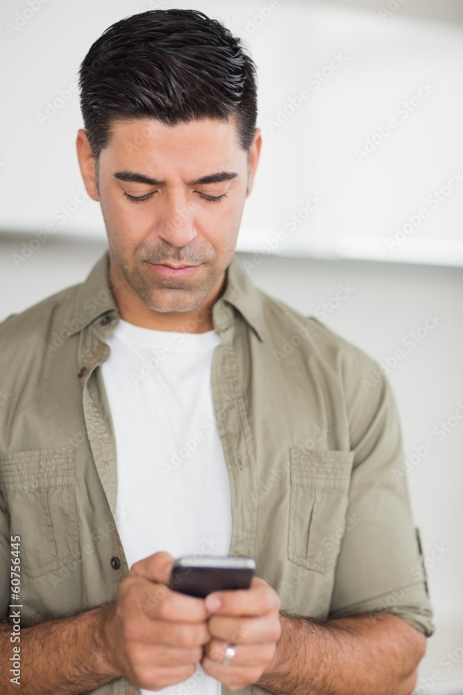 Serious man text messaging Serious man text messaging