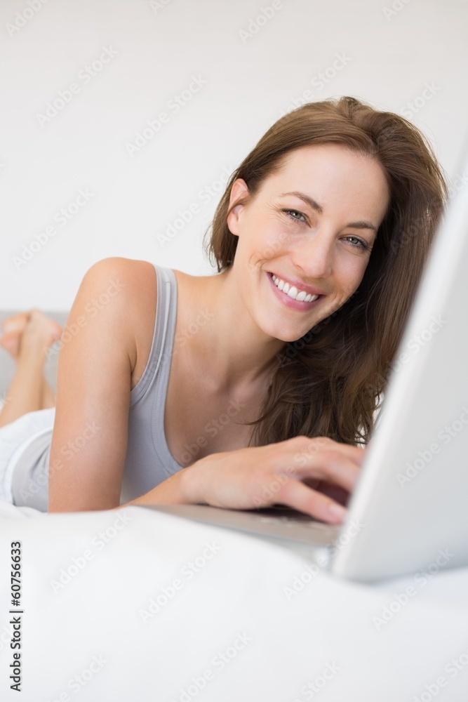 Portrait of relaxed woman using laptop in bed Portrait of relaxed woman using laptop in bed