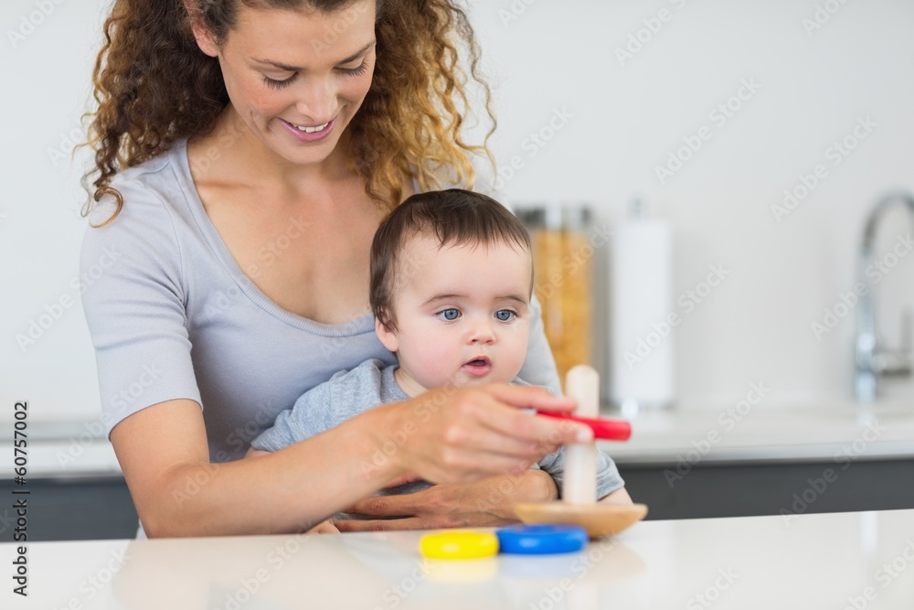 Baby boy looking at mother playing with toys Baby boy looking at mother playing with toys