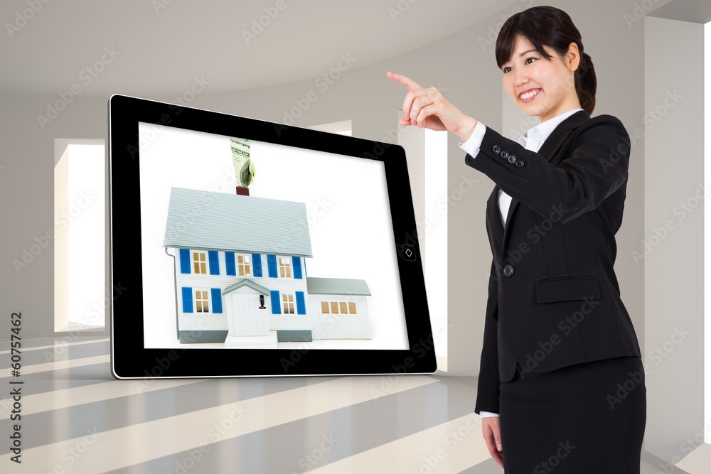 Composite image of smiling businesswoman pointing