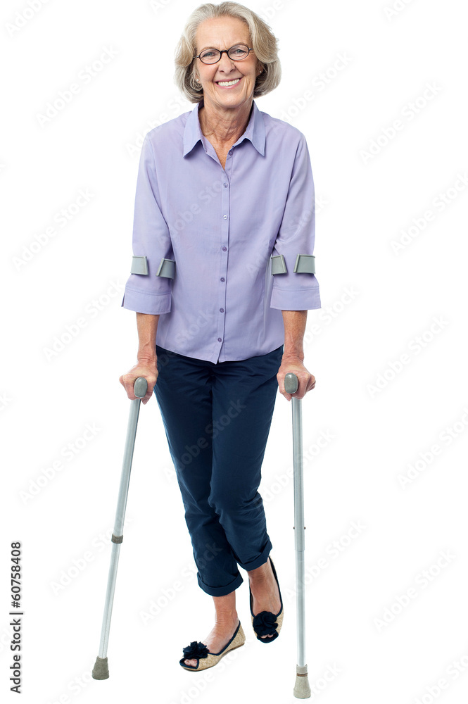 Old woman walking with crutches