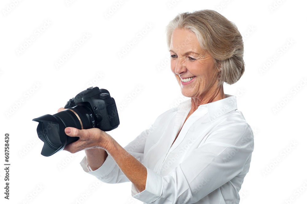 Experienced female photographer with camera Experienced female photographer with camera