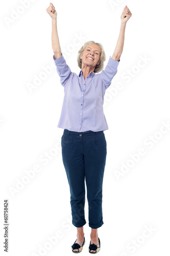 Full length image of excited aged lady