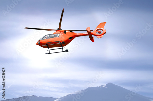 Rescue helicopter over mountain summits photo