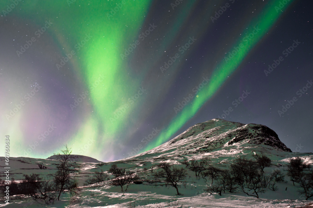 Northern lights above mountain hill. Captured near Skibon, Norwa