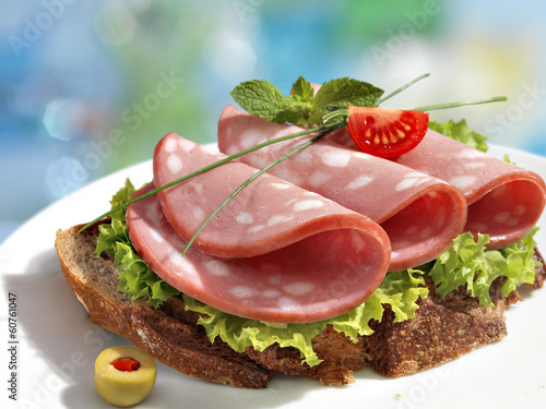 Delicious sandwich with sausage and greens