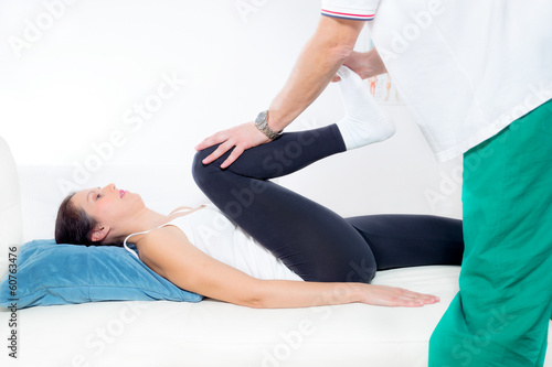 Chiropractor Works on the Patient Leg 