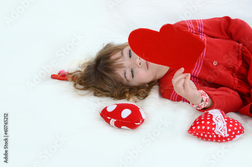 Beautiful girl playing with hearts photo