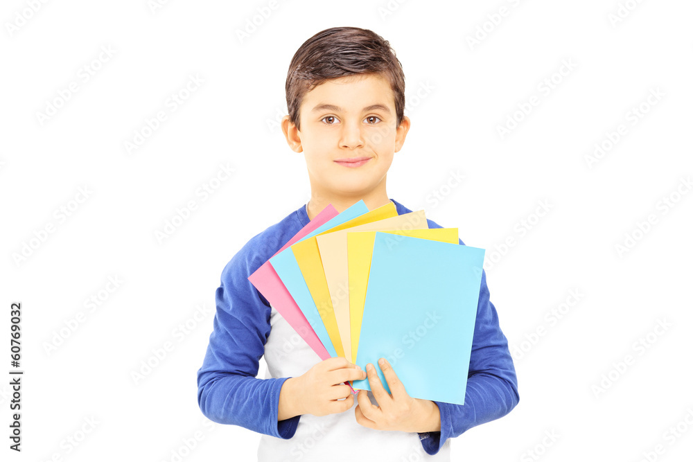 Boy holding cards in different colors and looking at camera Boy holding cards in different colors and looking at camera