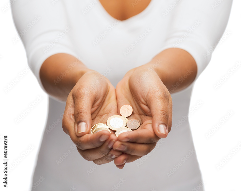 womans cupped hands showing euro coins womans cupped hands showing euro coins