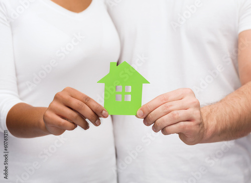 couple hands holding green house