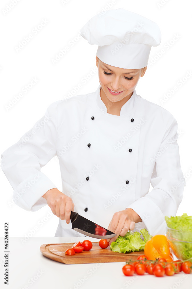 smiling female chef chopping vagetables smiling female chef chopping vagetables