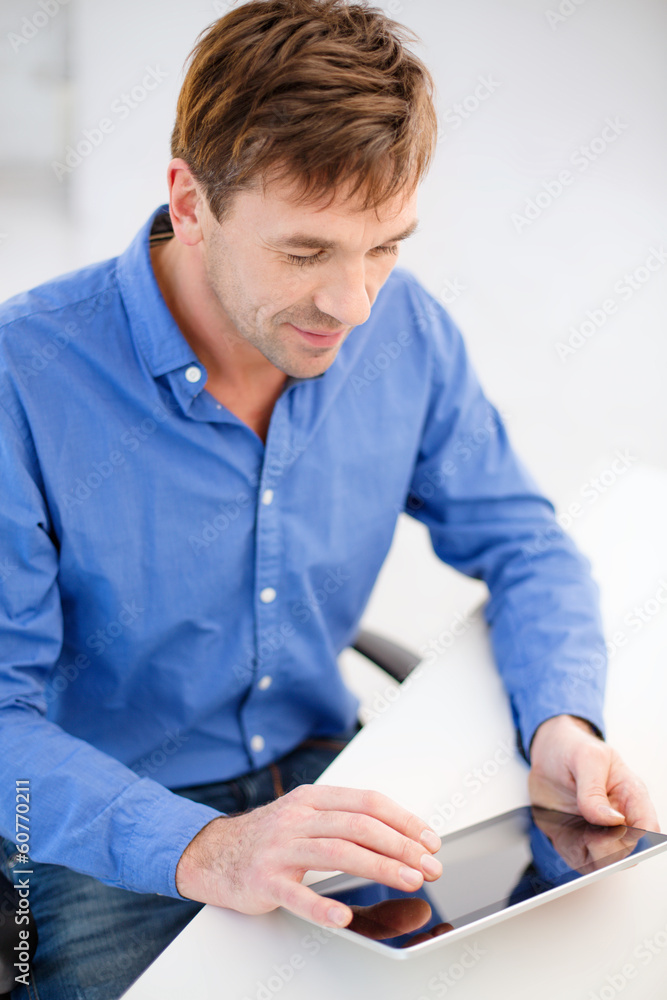 man working with tablet pc at home