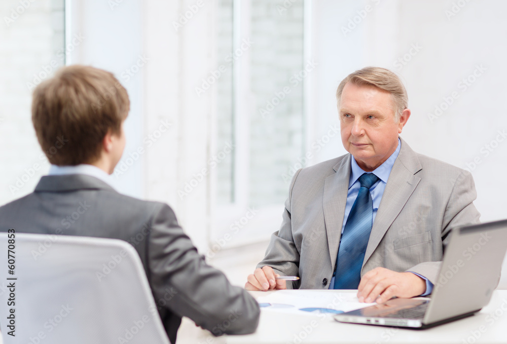 Fototapeta premium older man and young man having meeting in office