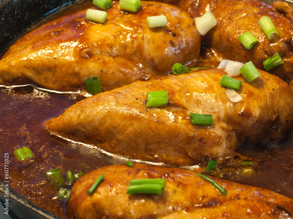 Chicken Breasts Cooking in a Cast Iron Pan with Green Onions Chicken Breasts Cooking in a Cast Iron Pan with Green Onions