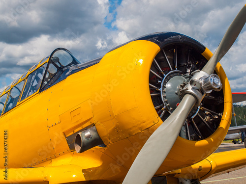 Vintage Yellow Propeller Aircraft Parked at an Airport