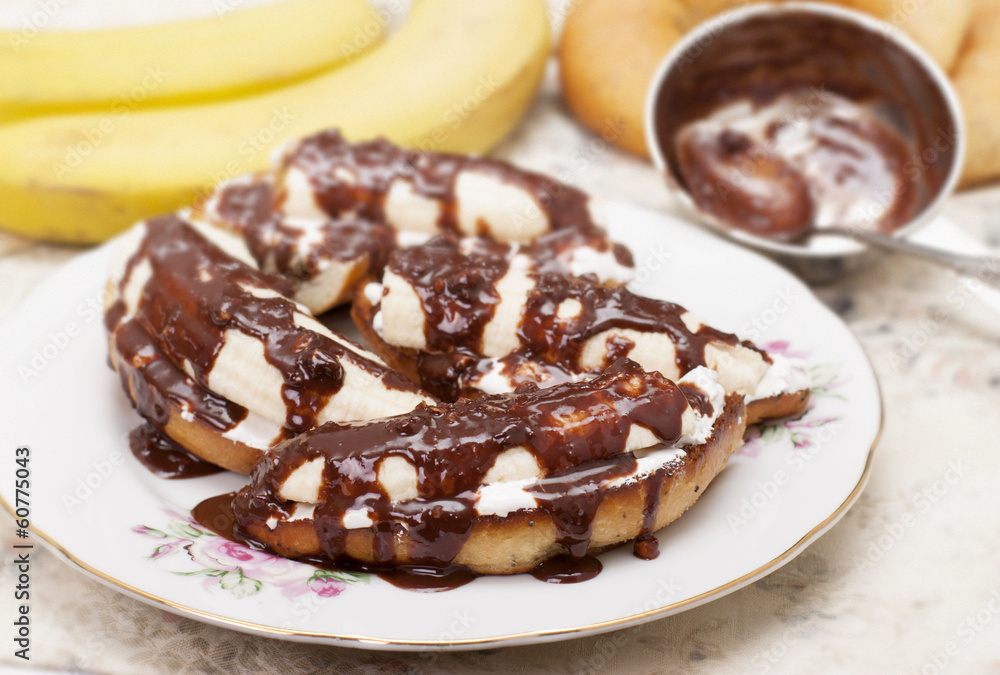 Bananas on toasted white bread with white cream and chocolate. Bananas on toasted white bread with white cream and chocolate.
