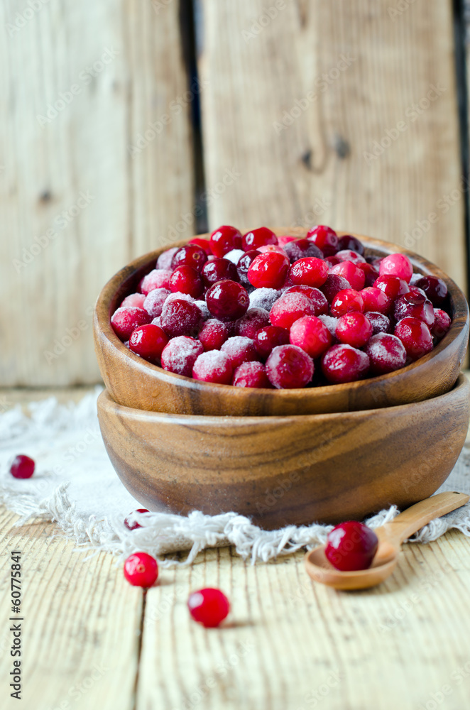 Cranberries in a wooden bowl on a wooden table Cranberries in a wooden bowl on a wooden table