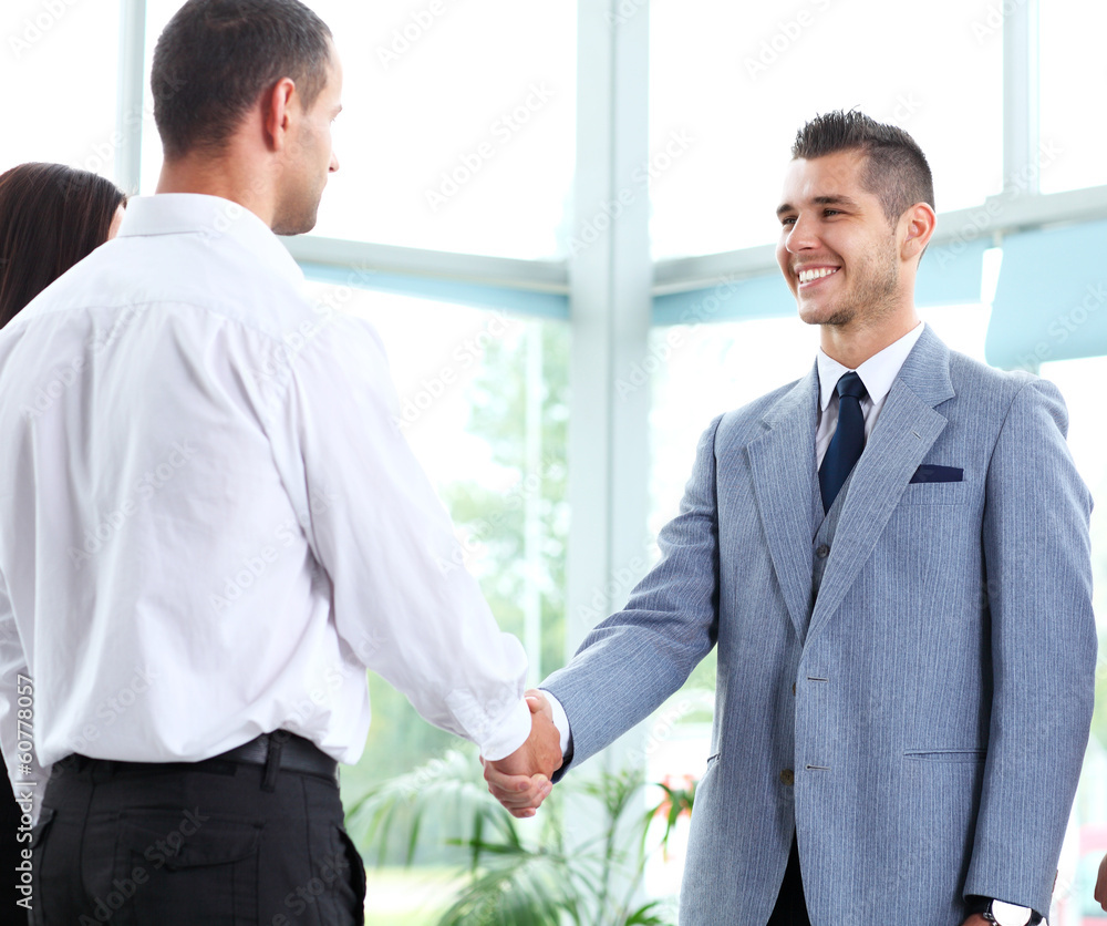 Business people shaking hands, finishing up a meeting Business people shaking hands, finishing up a meeting