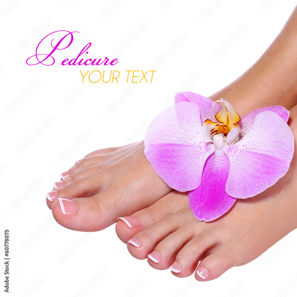 Pedicure with pink orchid flower isolated