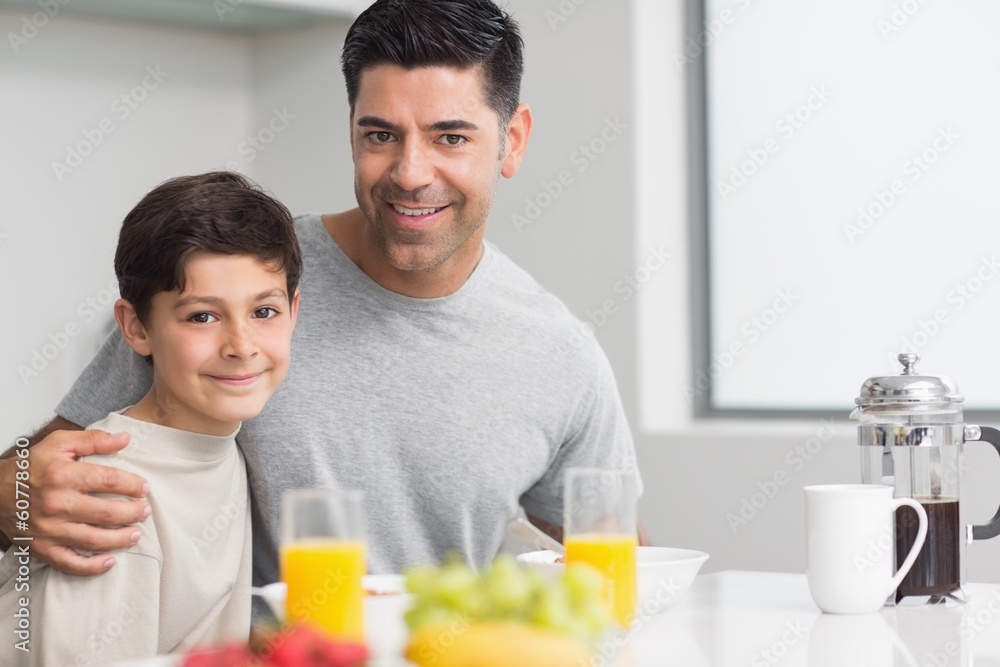 Portrait of happy son with father having breakfast Portrait of happy son with father having breakfast
