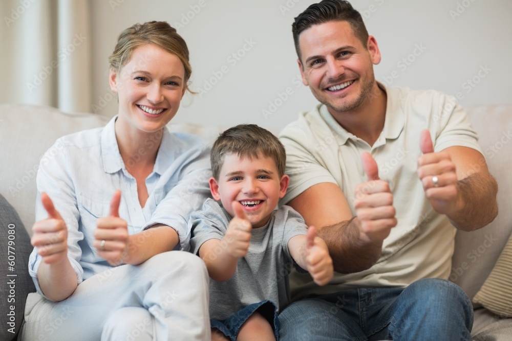 Family gesturing thumbs up on sofa Family gesturing thumbs up on sofa