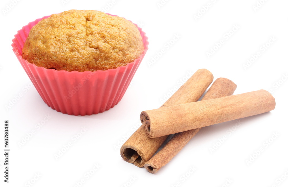 Fresh baked carrot muffin and cinnamon stick. White background Fresh baked carrot muffin and cinnamon stick. White background