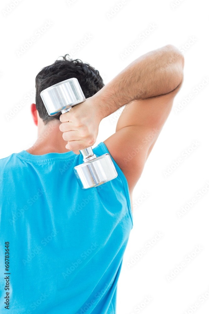Rear view of a young man exercising with dumbbell Rear view of a young man exercising with dumbbell