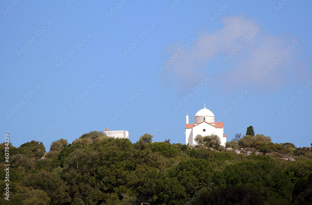 Orthodox chapel on a wooded hillside on the island of Crete