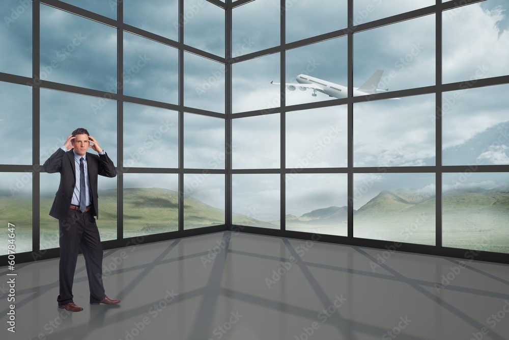 Composite image of stressed businessman with hands on head Composite image of stressed businessman with hands on head