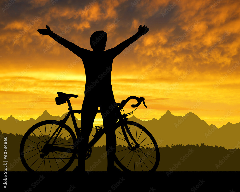 Obraz premium Silhouette of the cyclist on road bike at sunset