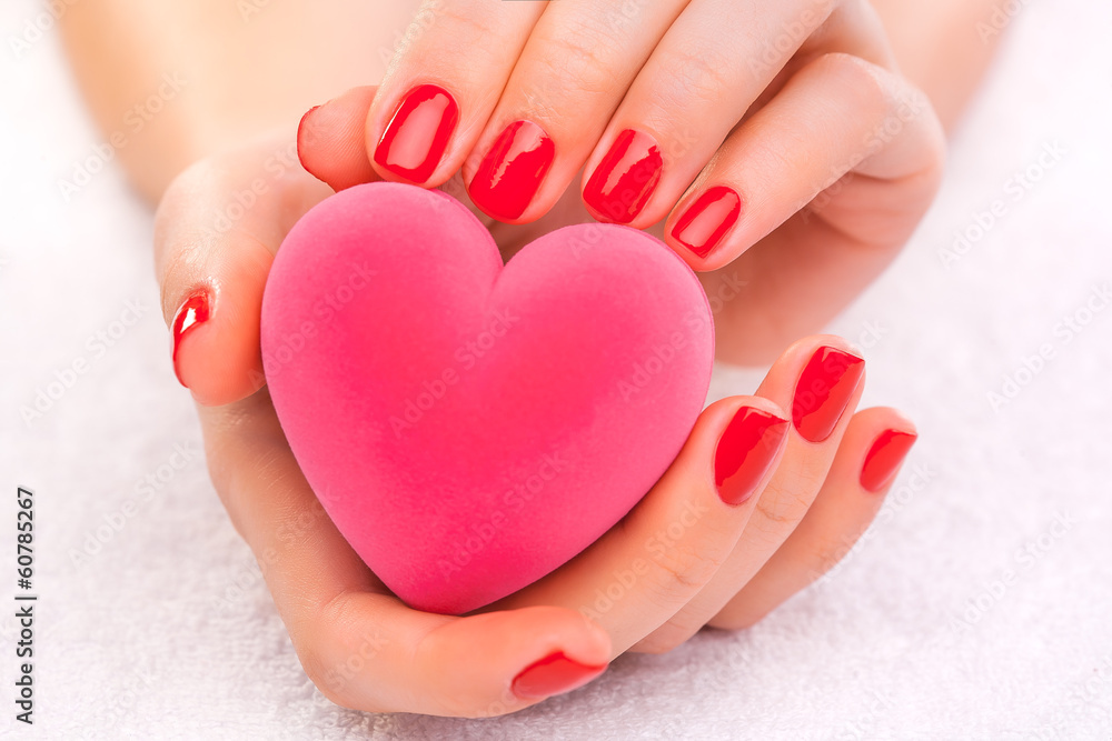 red manicure with gift box on the white towel red manicure with gift box on the white towel