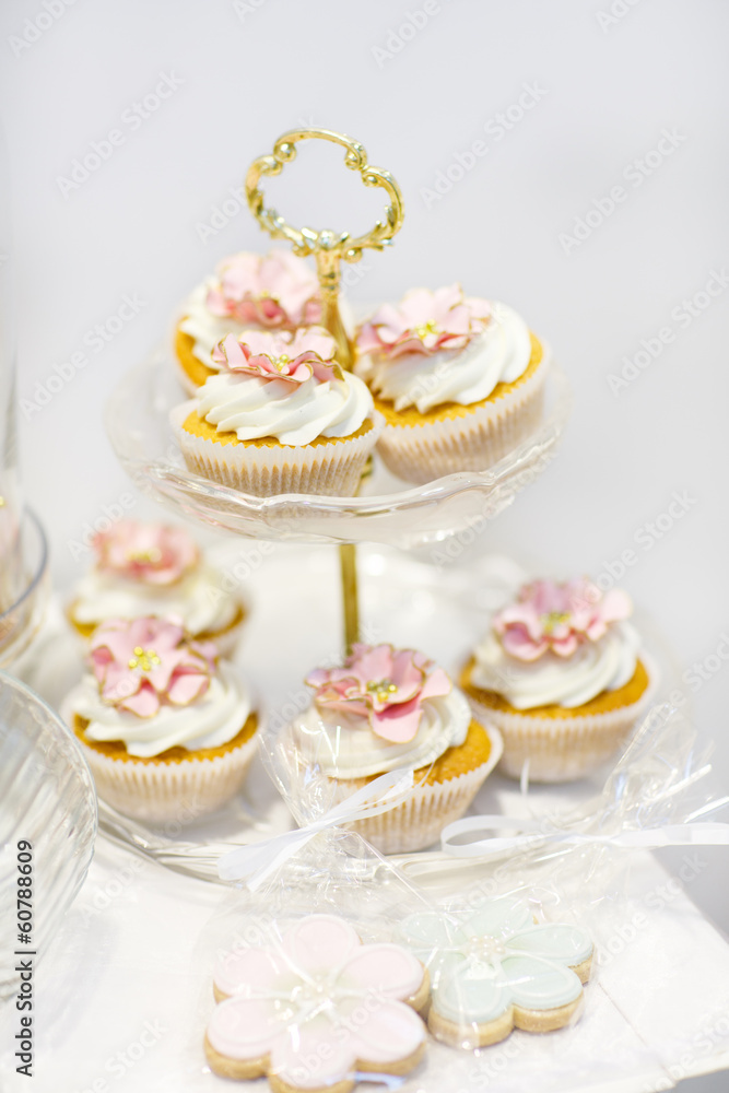 Elegant sweet table with cupcakes and other sweets for dinner or Elegant sweet table with cupcakes and other sweets for dinner or