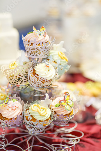 Elegant sweet table with cupcakes and other sweets for dinner or © Irina Schmidt