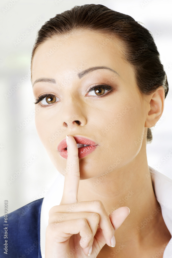 Portrait of attractive business woman with finger on lips Portrait of attractive business woman with finger on lips