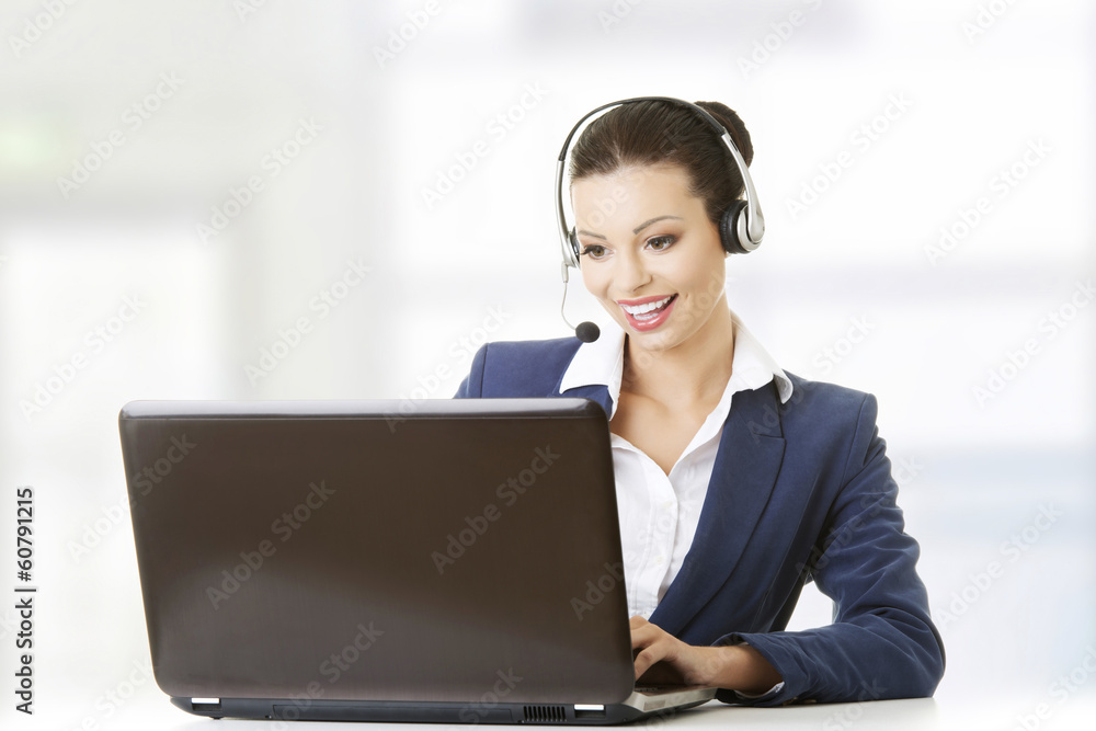 Beautiful young call-center assistant at the desk Beautiful young call-center assistant at the desk