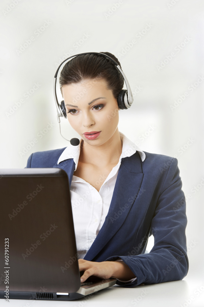 Beautiful young call-center assistant at the desk Beautiful young call-center assistant at the desk