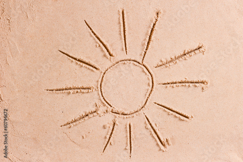 beautiful drawing of the sun with rays on the sand