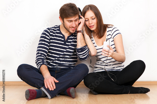 Two people listening to music