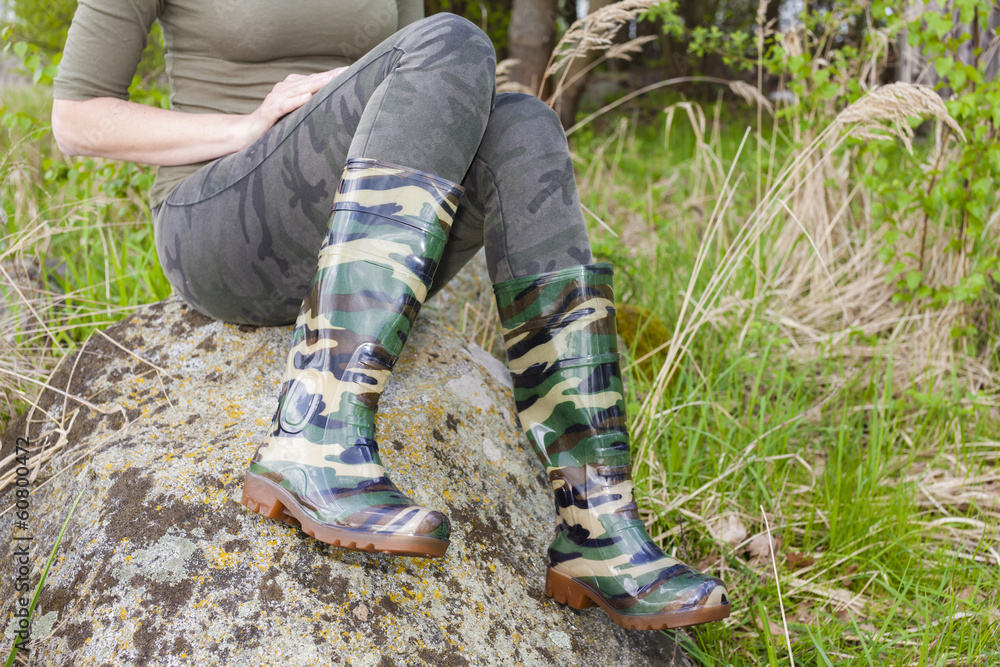 detail of woman wearing rubber boots in spring nature detail of woman wearing rubber boots in spring nature