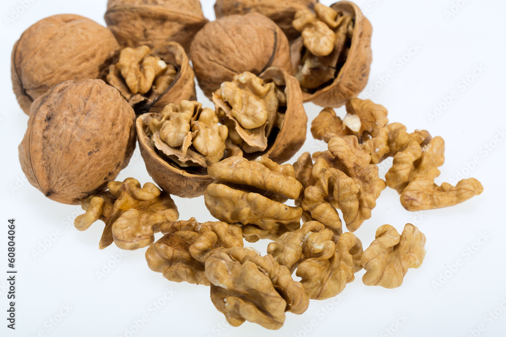 walnut and a cracked walnut isolated on the white background walnut and a cracked walnut isolated on the white background