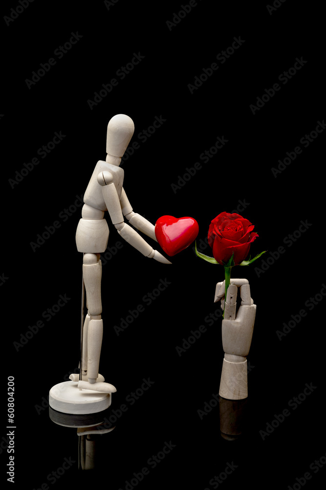Two wooden mannequins holding red heart and red rose Two wooden mannequins holding red heart and red rose