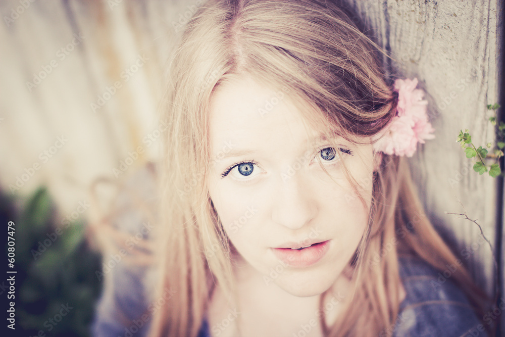 Beautiful blond girl with a spring flower in her hair Stock Photo ...