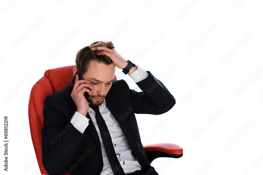 Worried businessman chatting on his mobile Worried businessman chatting on his mobile