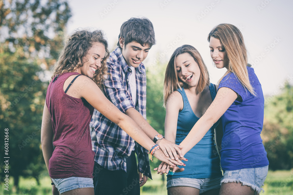 Group of Teenagers with Hands on Stack Group of Teenagers with Hands on Stack